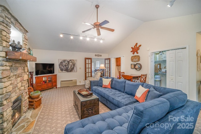 carpeted living room with ceiling fan, high vaulted ceiling, and a fireplace