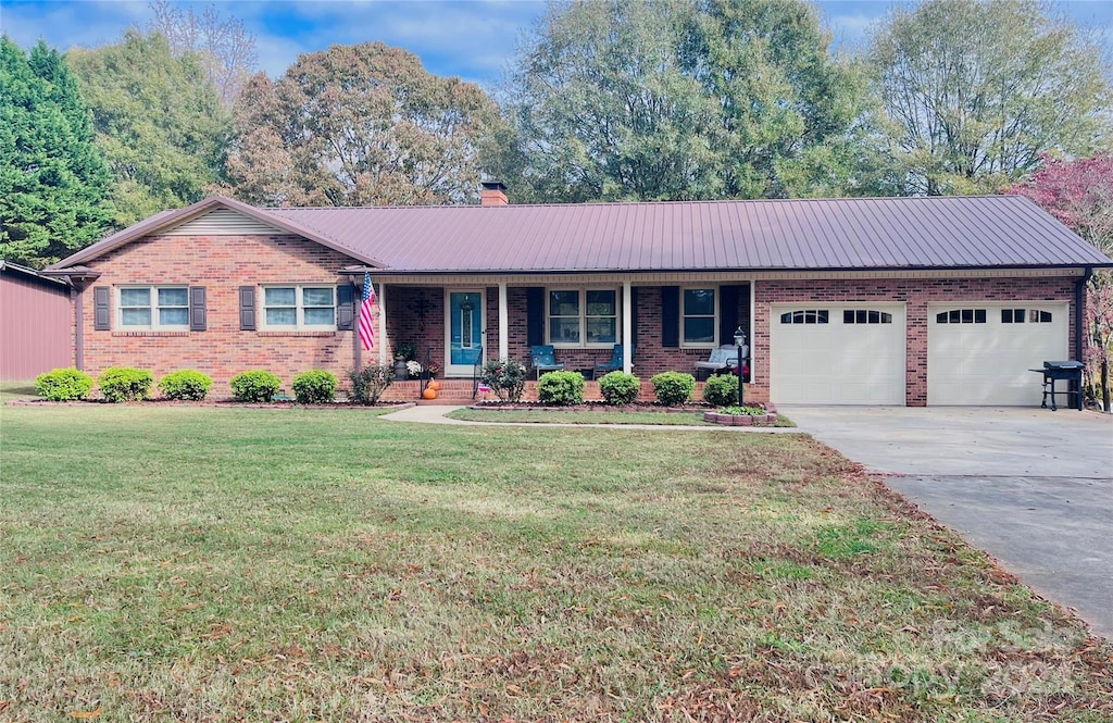 single story home with a front yard and a garage