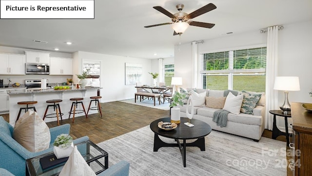 living room featuring light hardwood / wood-style flooring and ceiling fan