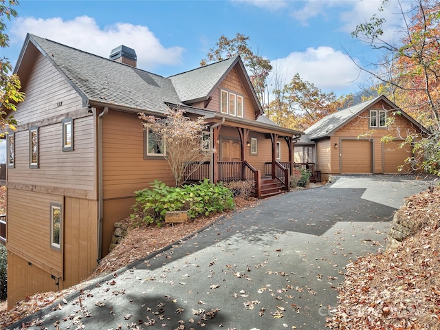 exterior space featuring covered porch and a garage