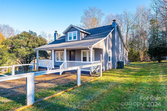 view of front of property with central AC unit, a porch, and a front yard