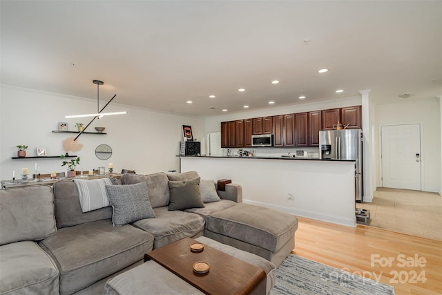 living room featuring crown molding and light wood-type flooring