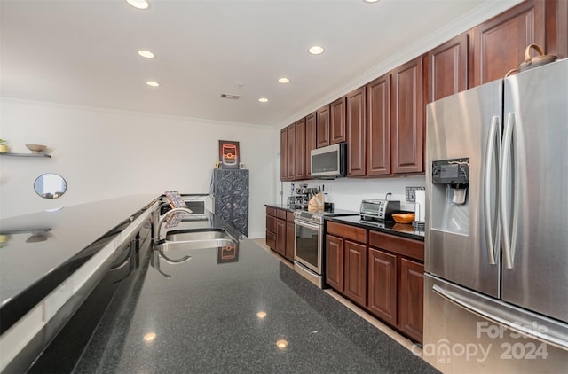 kitchen featuring ornamental molding, stainless steel appliances, and sink