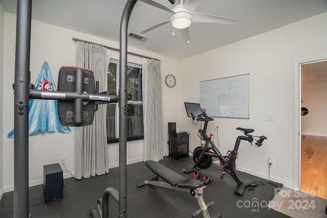 workout room with dark wood-type flooring and ceiling fan