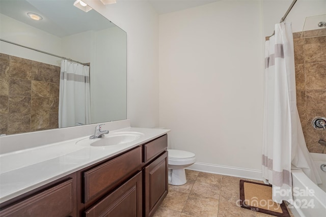 full bathroom featuring vanity, shower / bath combo with shower curtain, and toilet