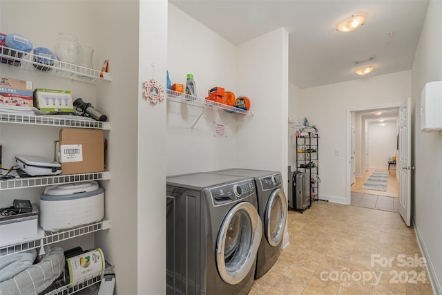 clothes washing area featuring separate washer and dryer