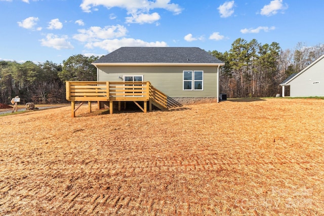 rear view of property featuring a wooden deck