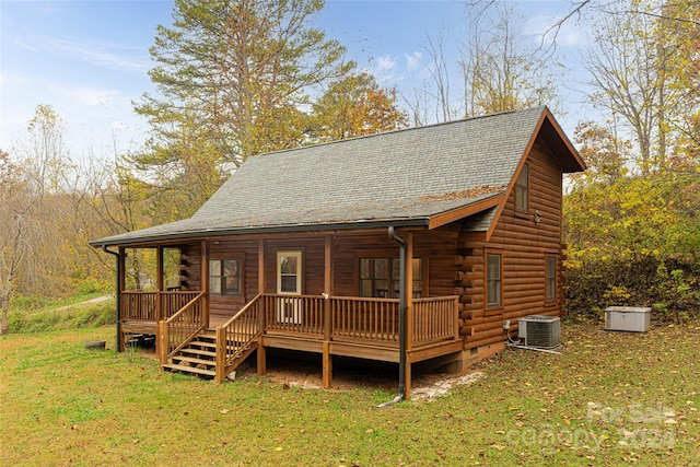 exterior space featuring central air condition unit, a yard, and a wooden deck