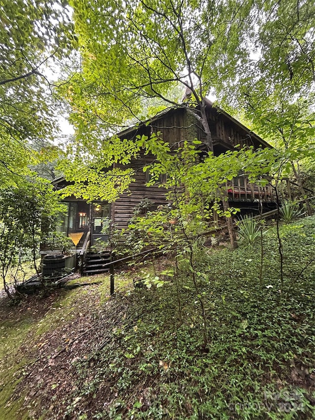 view of side of property with a wooden deck