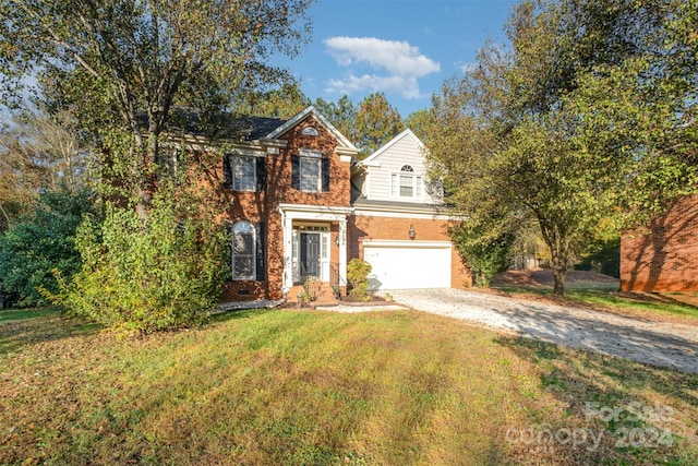 view of front of property featuring a front lawn and a garage