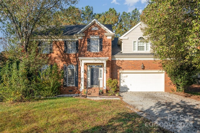 view of front facade with a front yard and a garage