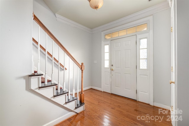 foyer featuring light hardwood / wood-style floors and ornamental molding