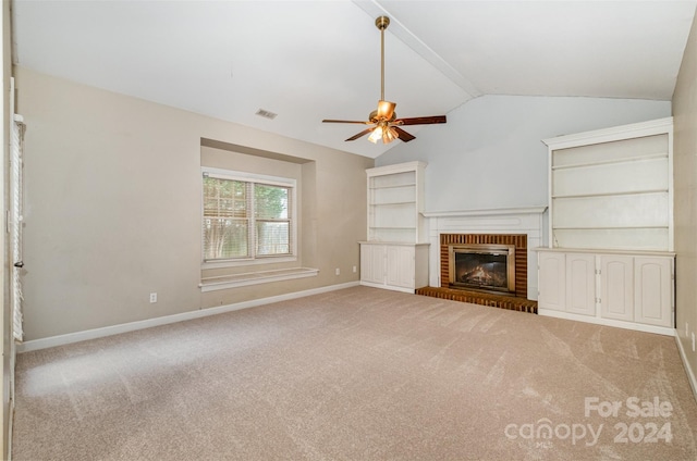 unfurnished living room with a fireplace, ceiling fan, lofted ceiling, and light carpet