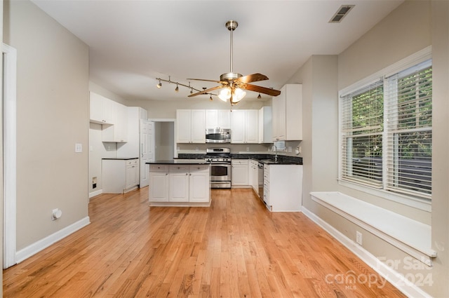 kitchen featuring sink, light hardwood / wood-style flooring, ceiling fan, appliances with stainless steel finishes, and white cabinetry