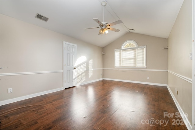 spare room featuring lofted ceiling, ceiling fan, and dark wood-type flooring