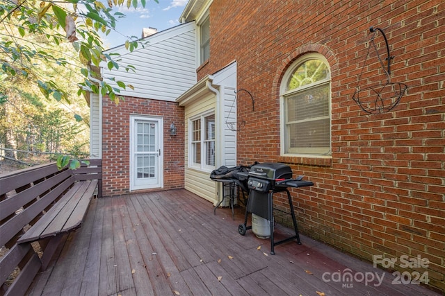 wooden terrace featuring grilling area