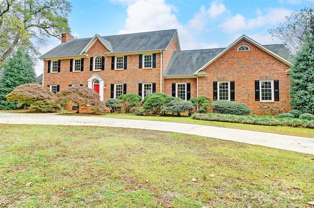 colonial inspired home with a front yard