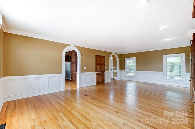 unfurnished room featuring crown molding and light hardwood / wood-style flooring