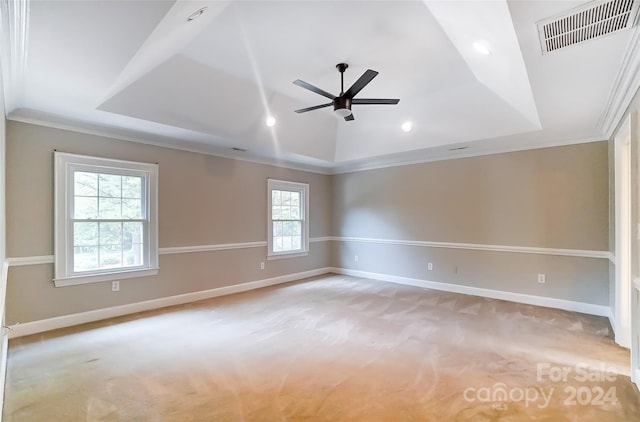 spare room featuring a healthy amount of sunlight, ornamental molding, and light carpet