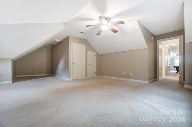 bonus room featuring ceiling fan, light carpet, and vaulted ceiling