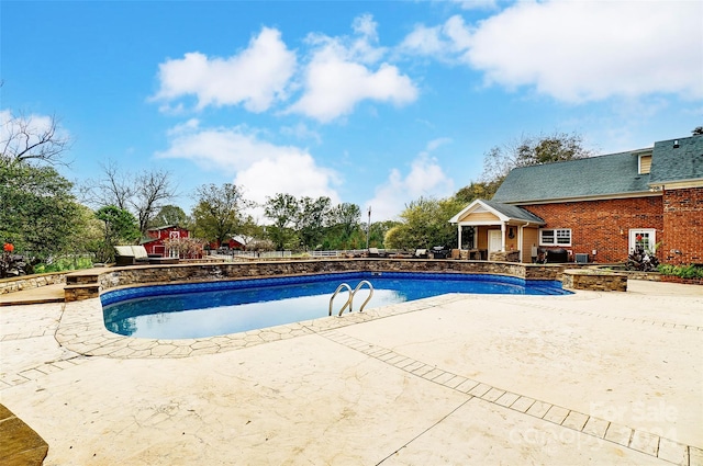 view of swimming pool with a patio