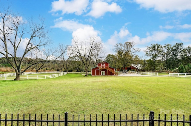 view of yard featuring a rural view and an outbuilding