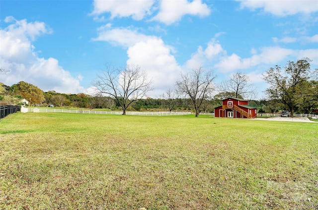 view of yard with an outbuilding and a rural view