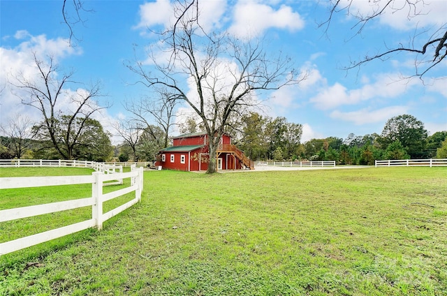 view of yard with an outbuilding and a rural view