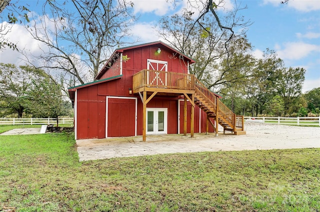 view of outbuilding with french doors and a yard