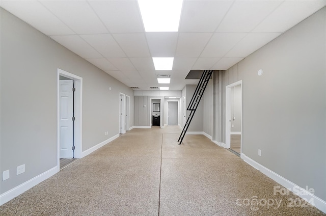 basement featuring a paneled ceiling