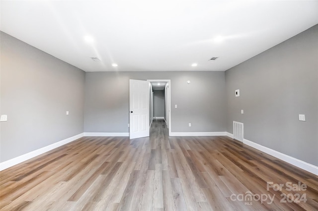 empty room with light hardwood / wood-style flooring