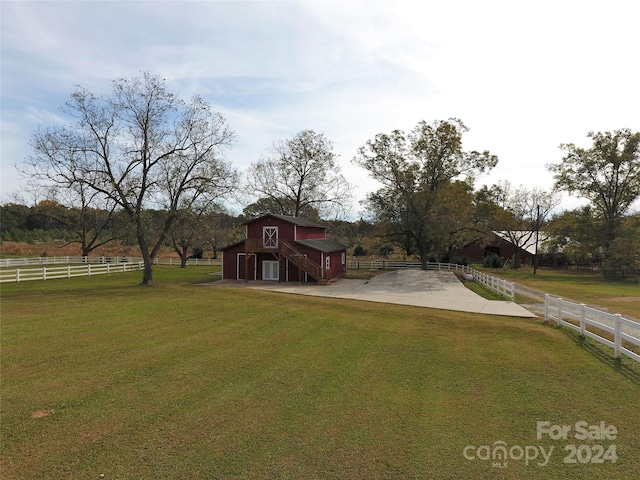 view of yard with a rural view and an outdoor structure