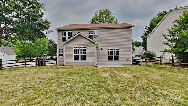 rear view of property with a lawn