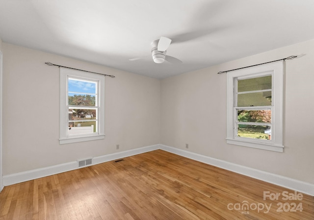 spare room with ceiling fan and wood-type flooring