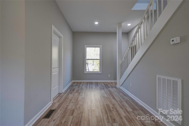 empty room with light hardwood / wood-style floors