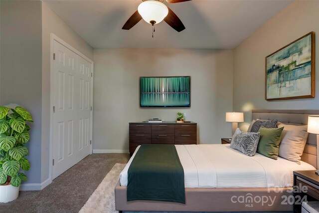 bedroom featuring a closet, light colored carpet, and ceiling fan