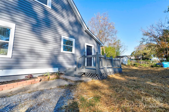 view of side of home featuring a wooden deck