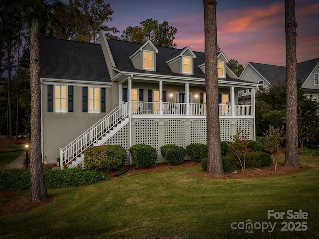 view of front of house with a lawn and covered porch