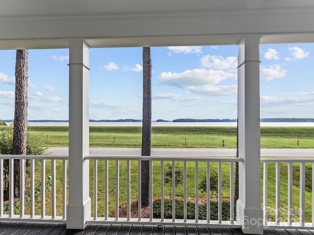 unfurnished sunroom featuring plenty of natural light and a rural view