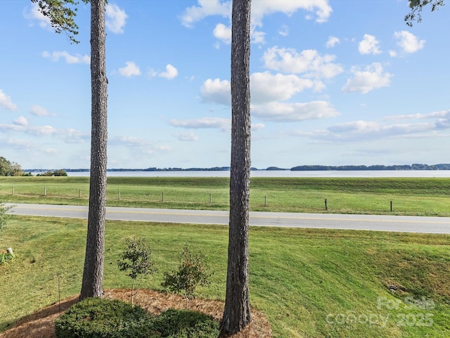 view of yard featuring a rural view and a water view