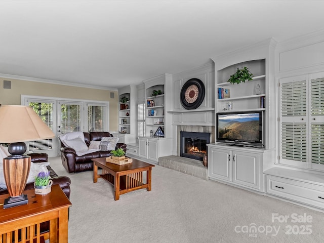 carpeted living room featuring built in features, ornamental molding, and a fireplace