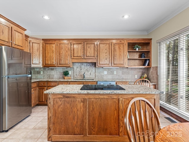 kitchen featuring a center island, crown molding, sink, stainless steel fridge, and light tile patterned floors