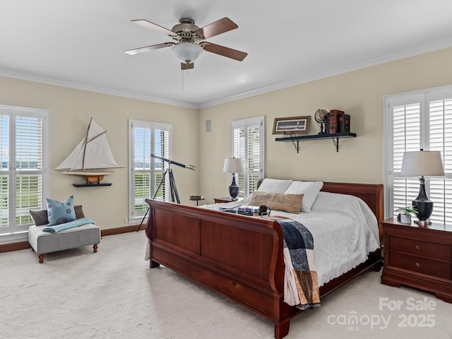 carpeted bedroom with multiple windows, ceiling fan, and crown molding