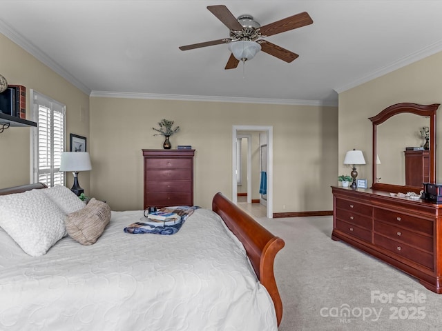 carpeted bedroom featuring ceiling fan and crown molding