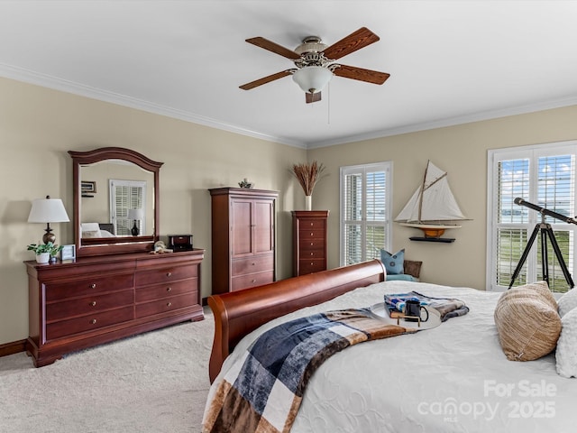 carpeted bedroom with ceiling fan and crown molding