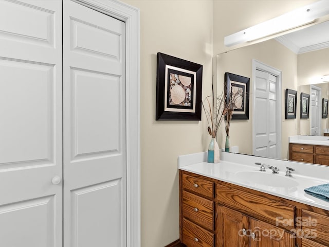 bathroom with vanity and ornamental molding