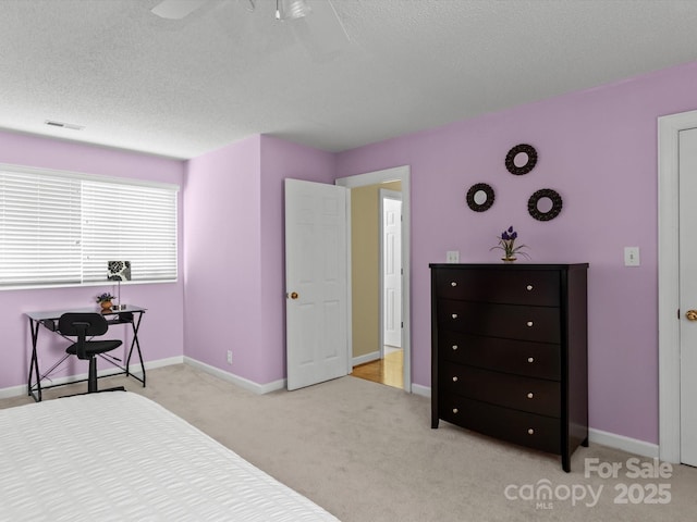 carpeted bedroom featuring a textured ceiling