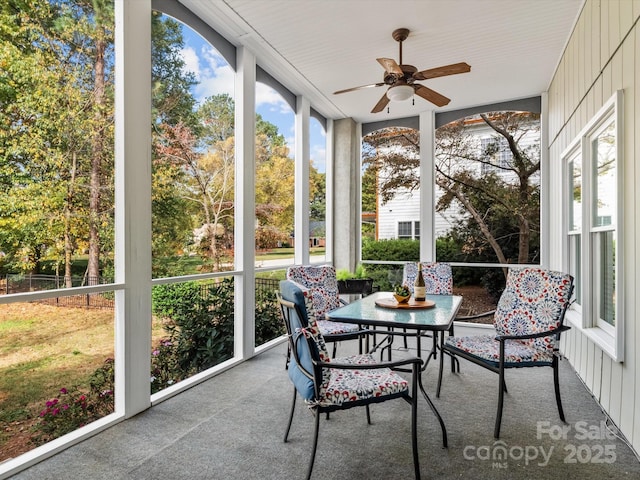 sunroom / solarium featuring ceiling fan