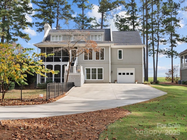 view of front of home with a front yard and a garage