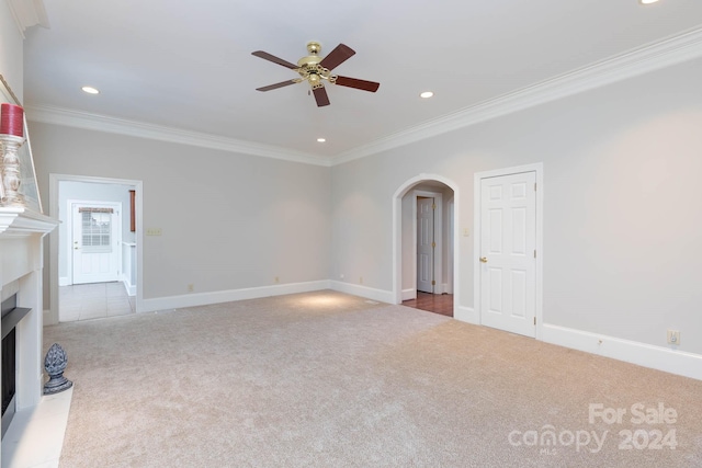 unfurnished living room featuring ceiling fan, light colored carpet, and crown molding